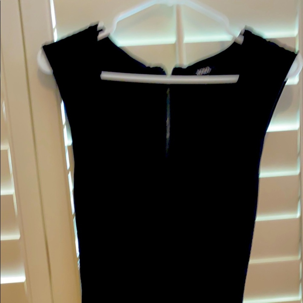 Black fitted dress with ruffle bottom